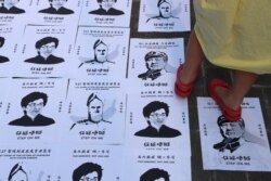 A child stands on a Lennon Wall placed on the ground in the Admiralty district of Hong Kong, Sept. 28, 2019
