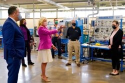 First lady Jill Biden, third from left, speaks during a visit with Education Secretary Miguel Cardona, left, to Sauk Valley Community College, in Dixon, Ill., April 19, 2021.