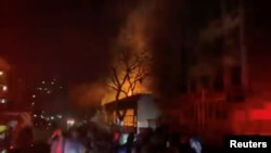 People gather near a building on fire in Johannesburg, South Africa, Aug. 31, 2023 City of Joburg EMS/Handout via REUTERS 