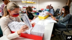 Lehigh County workers count ballots as vote counting in the general election continues, Thursday, Nov. 5, 2020, in Allentown, Pa. (AP Photo/Mary Altaffer)
