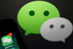 FILE PHOTO: The messenger app WeChat is seen next to its logo in this illustration picture taken Aug. 7, 2020.