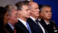 From left, White House press secretary Sarah Sanders, national security adviser John Bolton, FBI Director Christopher Wray, Director of National Intelligence Dan Coats and National Security Agency Director Gen. Paul Nakasone listen during the daily press briefing at the White House, Aug. 2, 2018.