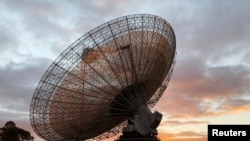A radio telescope at the Parkes Observatory is pictured at sunset near the town of Parkes, Australia, July 15, 2019. 