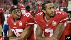 San Francisco 49ers safety Eric Reid (35) and quarterback Colin Kaepernick (7) kneel during the national anthem before an NFL football game against the Los Angeles Rams in Santa Clara, California, Sept. 12, 2016.