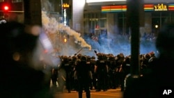 Police fire teargas as protestors converge on downtown following Tuesday's police shooting of Keith Lamont Scott in Charlotte, N.C.