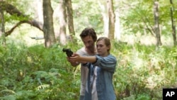 John Hawkes portrays a cult leader and Elizabeth Olsen is the young woman who escapes him in “Martha Marcy May Marlene.”