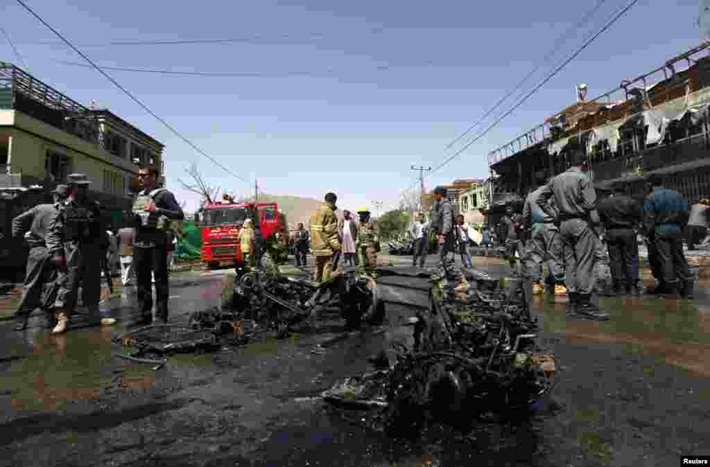 Afghan police stand guard at the site of a suicide attack in Kabul, May 16, 2013. 