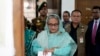 FILE - Sheikh Hasina checks her watch as she waits for the official opening time to cast her vote in Dhaka, Bangladesh, Jan. 7, 2024.