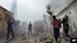 FILE - People run shortly after a rocket projectile fired from Syria landed in Kilis, Turkey, April 19, 2016. Turks abroad are hesitant to visit their homeland due to terror attacks and political uncertainties.