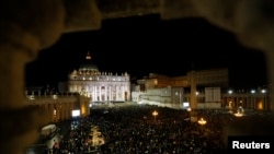 Faithful on St.Peter's Square cheer after white smoke rose from the chimney above the Sistine Chapel, indicating a new pope has been elected at the Vatican, March 13, 2013. White smoke rose from the Sistine Chapel and the bells of St. Peter's Basilica ran
