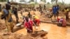 FILE - Miners work at a mining site in the Cameroonian town of Betare Oya, April 4, 2018.