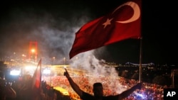 Pro-government supporters protest on the road leading to Istanbul's iconic Bosporus Bridge, background left, July 21, 2016. 