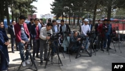 FILE - Journalists gather for a news event at Shahr-e-Naw Park in Kabul, Afghanistan, April 30, 2019. Since the Taliban's return to power, there has been a crackdown of independent media in Afghanistan. 