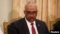 FILE - Prime Minister-designate Jack Guy Lafontant listens to a speech by President Jovenel Moise at the National Palace in Port-au-Prince, Haiti, Feb. 24, 2017.