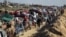 Palestinians, displaced to the south at Israel's order during the war, wait to have their vehicles inspected by the Egyptian-Qatari committee as they return to their homes in northern Gaza, near Gaza City, Jan. 27, 2025. 