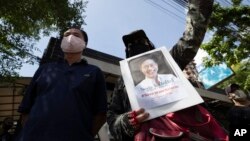 Activists gather for a rally with a photo of Thai dissident Wanchalearm Satsaksit in front of the Cambodian Embassy in Bangkok, Thailand, Monday, June 8, 2020. 