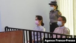 FILE - This handout photo taken May 24, 2021, and released by Myanmar's Ministry of Information May 26, shows detained civilian leader Aung San Suu Kyi (L) and detained president Win Myint (R) during their first court appearance in Naypyidaw. 