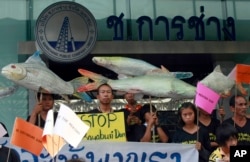 FILE - Thai villagers hold banners opposing the building of a dam on the Mekong river during a rally outside a construction company in Bangkok, Thailand, April 24, 2012. A new irrigation proposal — the Kong-Loei-Chi-Mun project — is sparking concerns from locals, environmentalists, and some development experts.