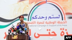 Houthi Military spokesman Yehia Sareea delivers a statement on the recent attacks against two commercial vessels in the Red Sea during a march in solidarity with the people of Gaza in Sanaa, Yemen, on Dec. 15, 2023.