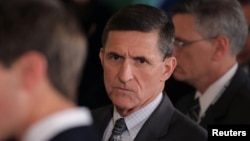 FILE - Then-White House National Security Adviser Michael Flynn, center, arrives at the White House in Washington, Feb. 13, 2017.