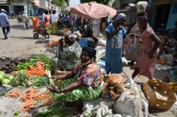 FILE - A women sells vegetable at a market in Ndjamena on Apr. 24, 2021, a day after Chad's late president Idriss Deby funeral.