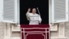 Pope Francis waves to faithful during the Angelus noon prayer in St. Peter's Square, at the Vatican, Jan. 6, 2022.