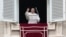 Pope Francis waves to faithful during the Angelus noon prayer in St. Peter's Square, at the Vatican, Jan. 6, 2022.
