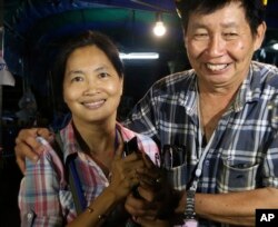 Family members smile after hearing the news that the missing 12 boys and their soccer coach have been found, in Mae Sai, Chiang Rai province, in northern Thailand, Monday, July 2, 2018. (AP Photo/Sakchai Lalit)