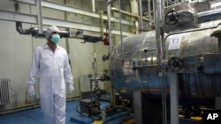 FILE - An Iranian technician walks through the Uranium Conversion Facility just outside the city of Isfahan, south of the capital Tehran.
