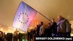 Ukraine -- A man holds a EU flag during a protest at Independence square in downtown Kyiv, November 22, 2013