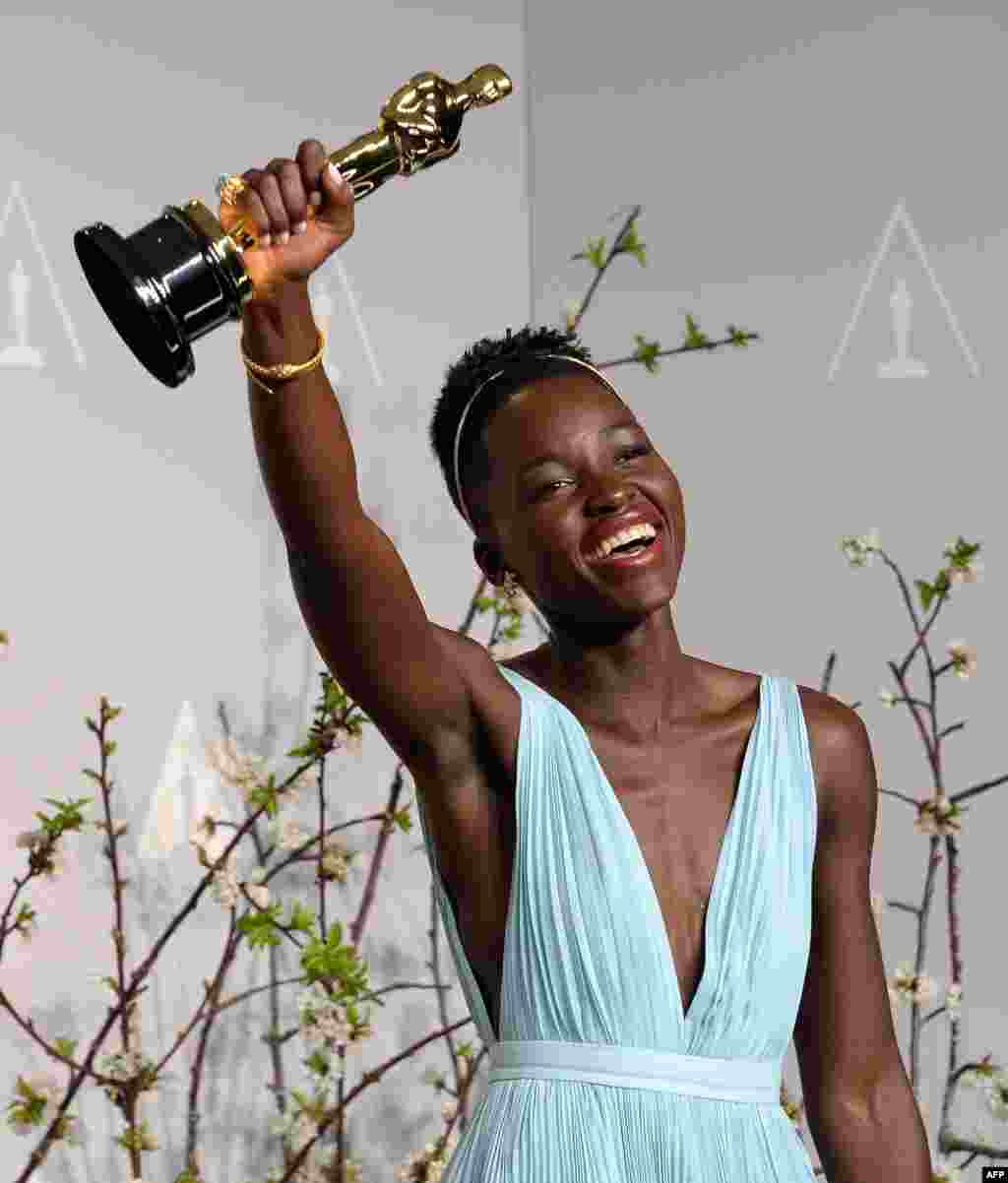 Actress Lupita Nyong&#39;o celebrates winning Best Performance by an Actress in a Supporting Role award for &#39;12 Years a Slave&#39; in the press room during the 86th Academy Awards in Hollywood, California, March 2, 2014. 