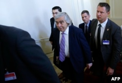FILE - Then-U.S. Secretary of Energy Ernest Moniz, center, arrives at a meeting in Vienna, Austria, July 9, 2015.