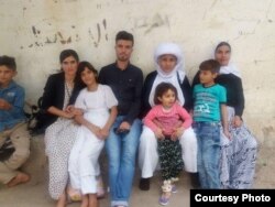 Dawood Saleh, a Yazidi from Sinjar who has resettled in the U.S., is pictured with his family in Sinjar before the Islamic State attack in 2014.