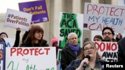 FILE - Laura Hayes (with microphone), of Fort Wayne, Indiana tells fellow protestors how the Affordable Care Act helped her with health costs, during a protest in front of the Supreme Court in Washington.