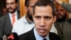 FILE - Venezuelan opposition leader and self-proclaimed interim president Juan Guaido talks to the media before a session of the Venezuela’s National Assembly in Caracas, Jan. 29, 2019. 