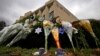 FILE - A makeshift memorial of flowers rests on bushes outside the Tree of Life synagogue in Pittsburgh, Nov. 20, 2018. 