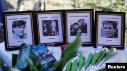 FILE - Photos of Koos Koster, Jan Kuiper, Joop Willemsen and Hans ter Laag, who were killed in 1982, are seen during the inauguration ceremony of the memorial built in their memory, in Santa Rita, El Salvador, Oct. 24, 2024. 