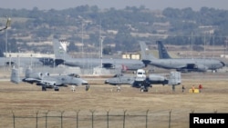Palestinian men perform fire breathing on the beach during summer vacation in Gaza City.