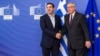 European Commission President Jean-Claude Juncker, right, welcomes Greece's Prime Minister Alexis Tsipras upon his arrival at the European Commission headquarters in Brussels, Feb. 4, 2015. 