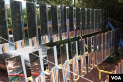 The South African designed Sol-4 solar thermal cooker consists of an array of 48 mirrors that reflect the sun and generate heat. (Darren Taylor for VOA)