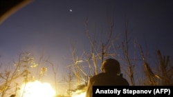 UKRAINE -- A Ukrainian serviceman shoots with a machine gun during a night combat with Russia-backed separatists near Avdiivka, Donetsk region, November 3, 2018.