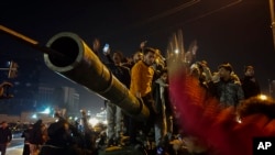 Syrians celebrate the arrival of opposition fighters in Damascus, Syria, Dec. 8, 2024.