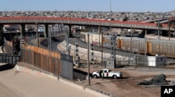 FILE - A new barrier is built along the Texas-Mexico border near downtown El Paso, Jan. 22, 2019. Such barriers have been a part of El Paso for decades and are currently being expanded.