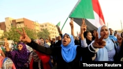 Sudanese protesters march during a demonstration to commemorate 40 days since a sit-in massacre, in Khartoum, Sudan, July 13, 2019. 