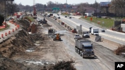 FILE - Work proceeds on an Interstate Highway 75 project in Hazel Park, Mich., April 20, 2020, President Joe Biden’s administration will soon begin touting the benefits of a proposed package of infrastructure investments.