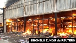 A fire engulfs Campsdrift Park following protests that have widened into looting in Pietermaritzburg, South Africa, July 13, 2021, in this screen grab taken from a video obtained from social media. (Courtesy Sibonelo Zungu/via Reuters)