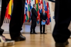 US Secretary of State Antony Blinken, right, accompanied by Secretary-General of the Organization for Economic Cooperation and Development (OECD) Mathias Cormann, of Australia, speaks at the OECD headquarters in Paris, June 25, 2021.