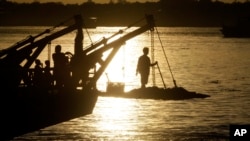 FILE - A passenger stands on the foredeck of a ferry as it crosses the Mekong river from Arey Ksat to the main city of in Phnom Penh, Cambodia. analysts say the U.S. decision to withdraw from the Paris agreement may have wide ranging ramifications for the Asia Pacific.