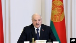 Belarus President Alexander Lukashenko speaks during a cabinet meeting in Minsk, Belarus, July 23, 2021. Belarusian authorities have ramped up raids and arrests of independent journalists and civil society activists in recent weeks.