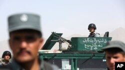 FILE - Peace talks between Afghans and the Taliban allegedly will resume soon. Here, Afghan security forces inspect a suicide attack site after clashes with Taliban fighters at an intelligence facility in Kabul, July 7, 2015.
